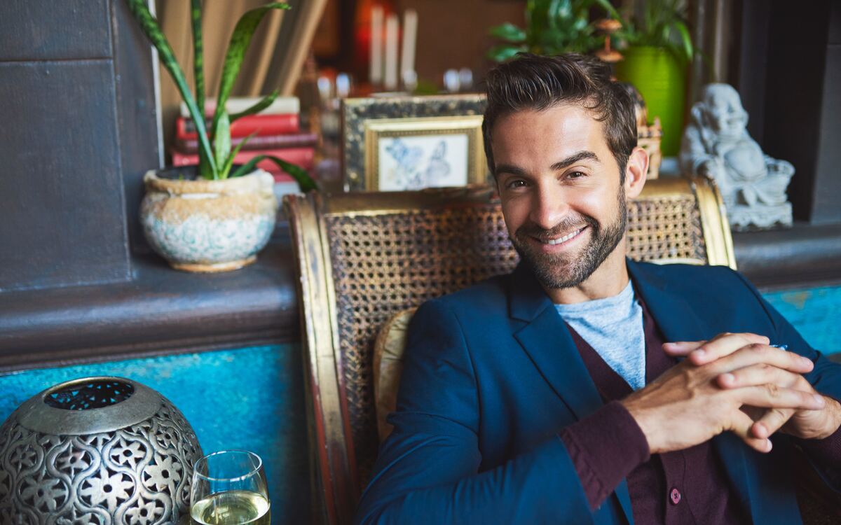 A man relaxing in a wicker chair, contemplative — the room you make for yourself when the work is yours alone.
