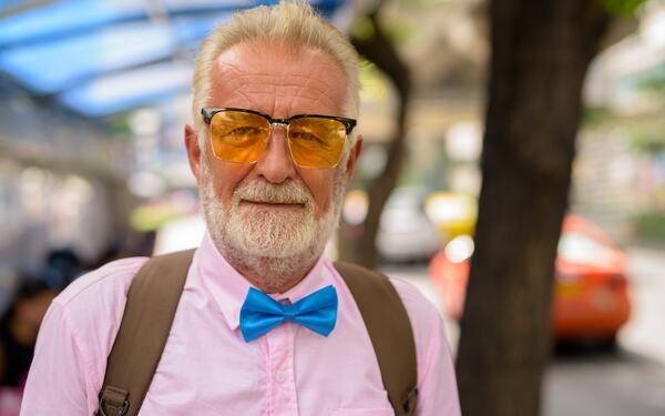 A senior man exploring a city, peaceful.